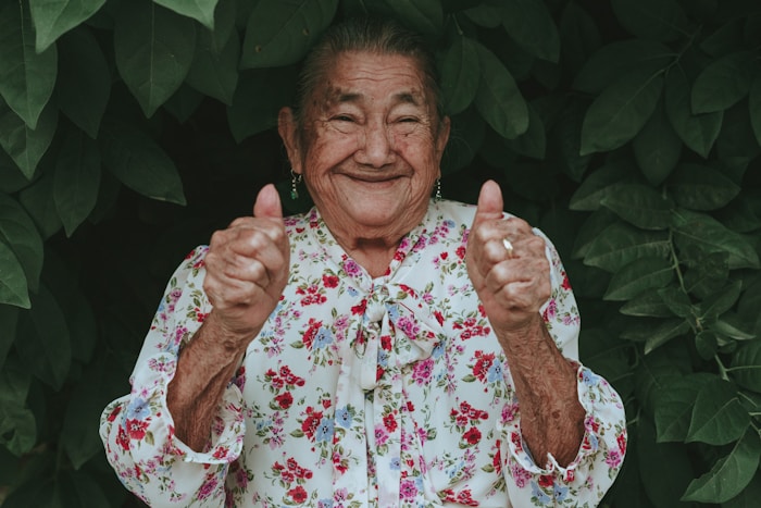 Happy senior giving two thumbs up
